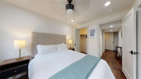 a bedroom with a bed and a lamp