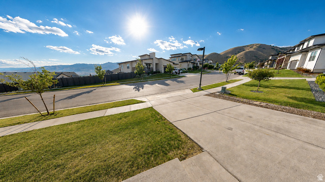 5502 North Valley View Road Lehi, UT 84048 - Photo 3 of 33 Suburban streetscape featuring concrete sidewalks and mature landscaping