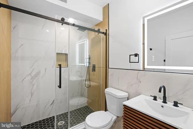 a bathroom with a sink toilet and shower