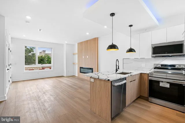a view of kitchen with sink and wooden floor