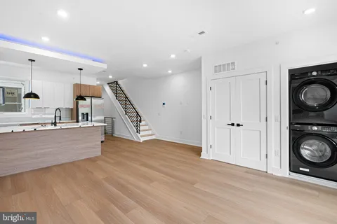 a view of kitchen with wooden floor and electronic appliances