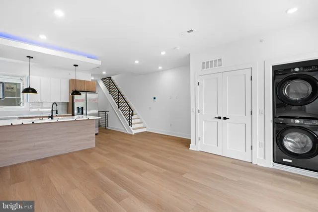 a view of kitchen with wooden floor and electronic appliances