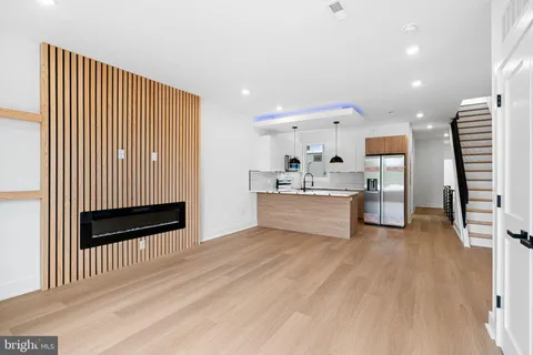 a kitchen with stainless steel appliances granite countertop a sink a refrigerator and a stove