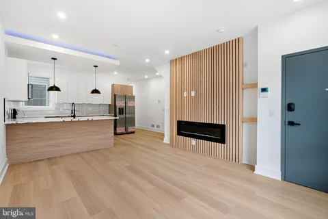 a view of kitchen with stainless steel appliances kitchen island granite countertop a refrigerator and a sink
