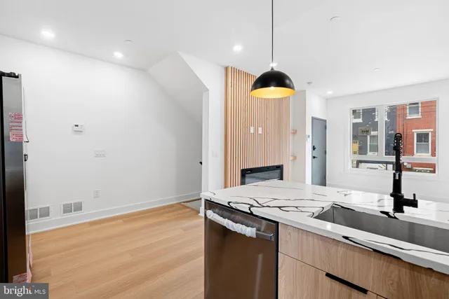 a room with a sink and hallway view
