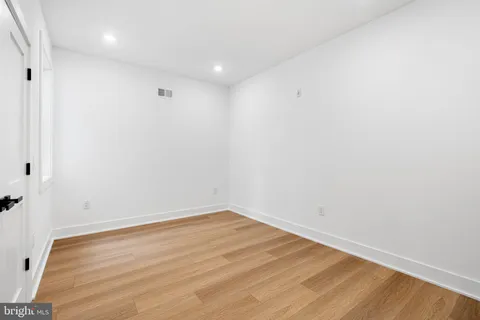 a view of room with wooden floor