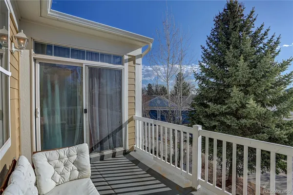 a view of a balcony with furniture