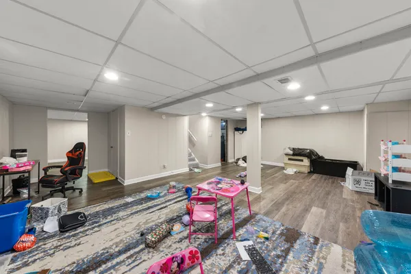 a bedroom with furniture and a wooden floor