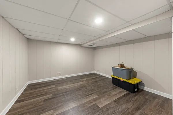 a room with wooden floor and a window