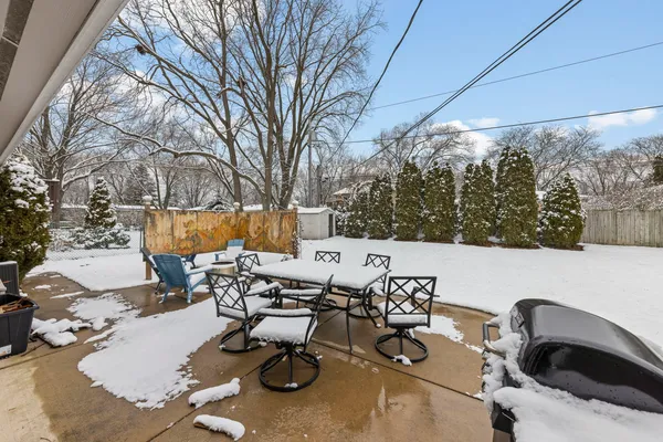 a view of backyard with seating area and trees