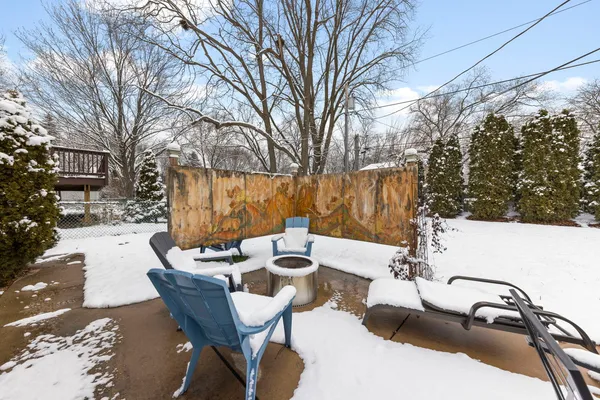 a view of backyard with seating space and trees