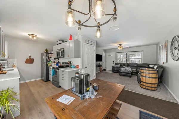a living room with furniture gym equipment and view of kitchen