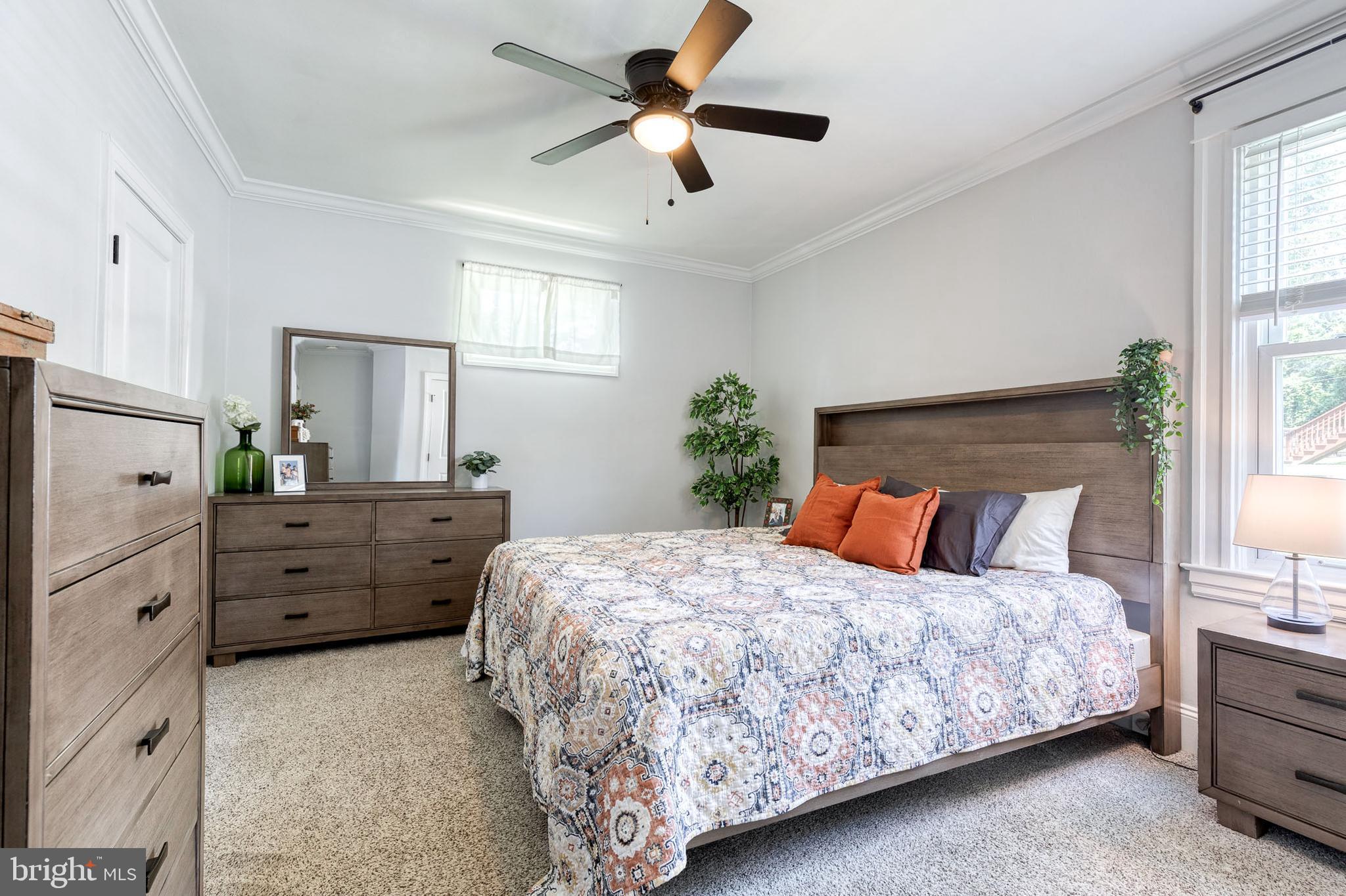 6504 Maplewood Road Baltimore, MD 21212 - Photo 19 of 45 a bedroom with a bed dresser and a window