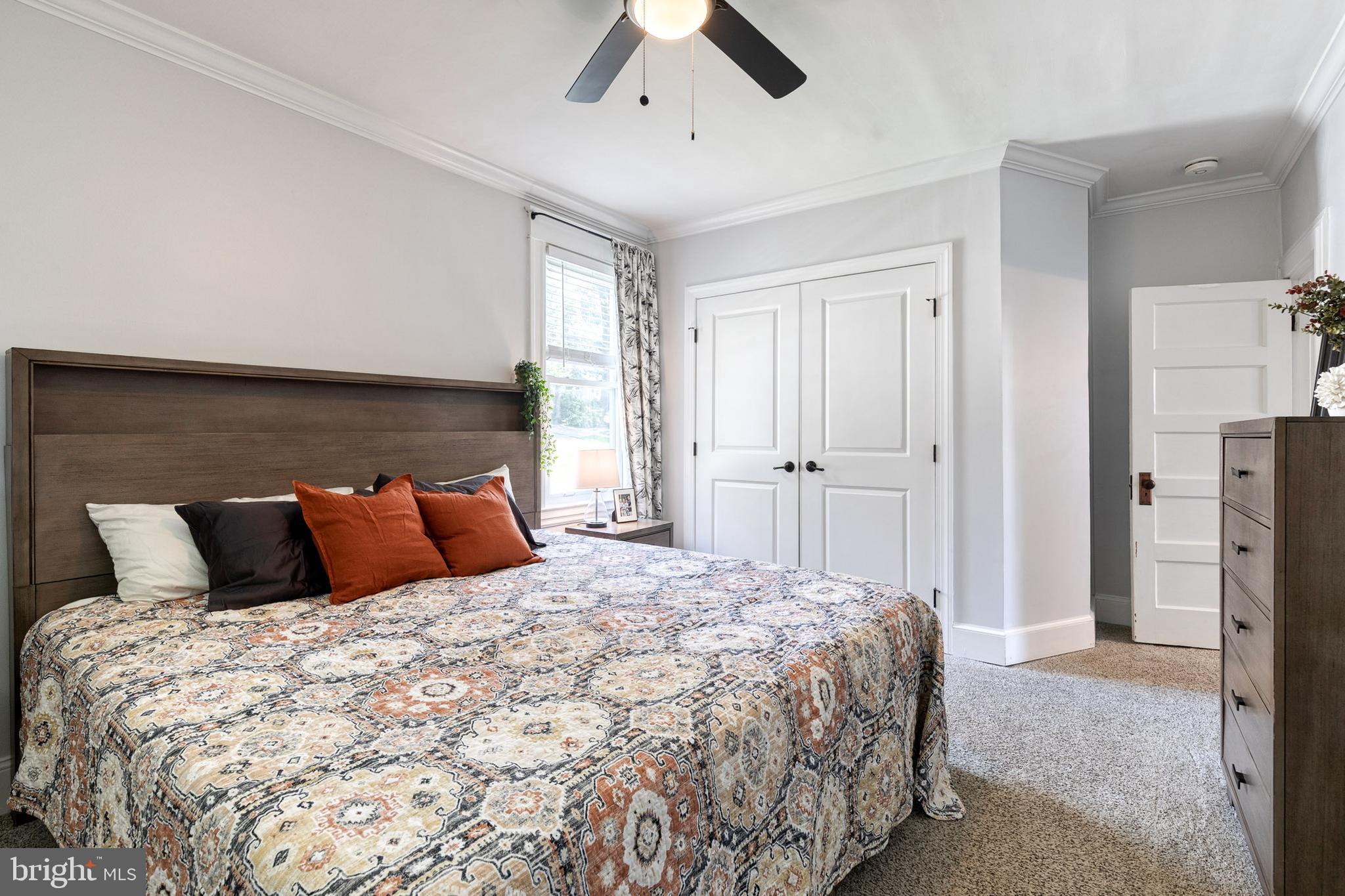 6504 Maplewood Road Baltimore, MD 21212 - Photo 20 of 45 a bedroom with a large bed and a chandelier