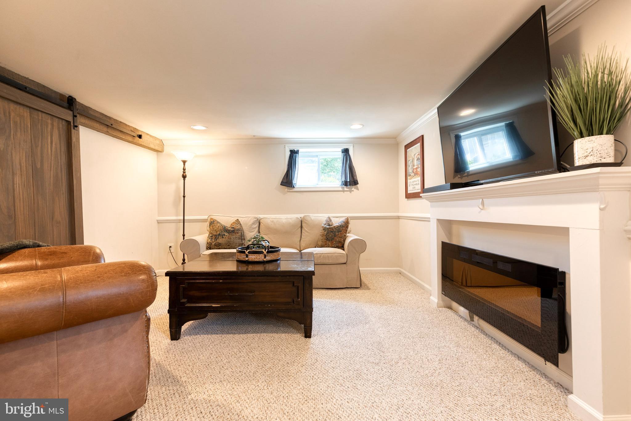 6504 Maplewood Road Baltimore, MD 21212 - Photo 26 of 45 a living room with furniture and a fireplace