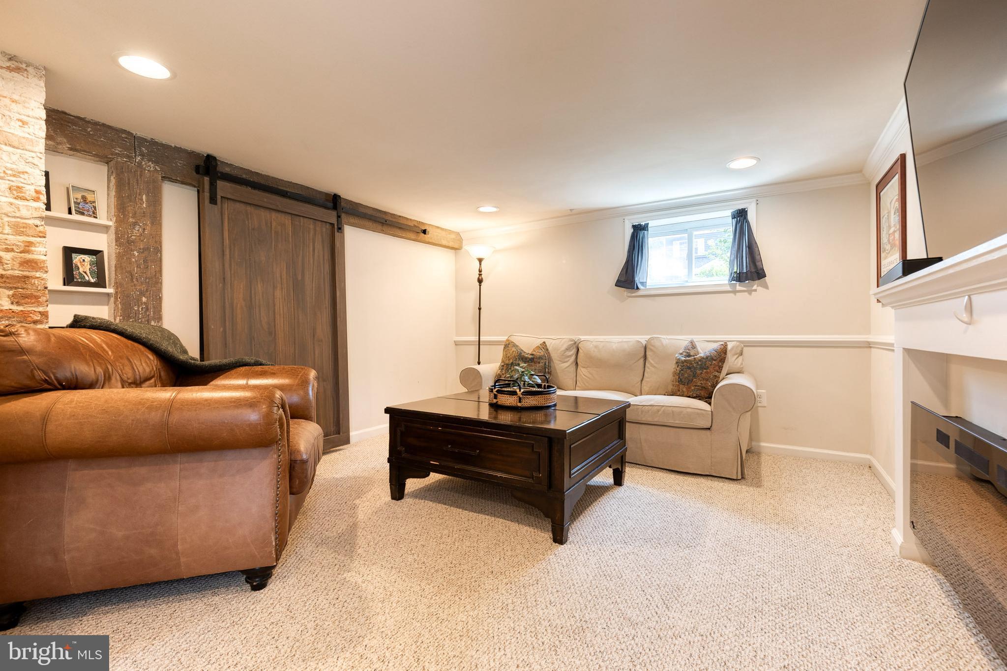 6504 Maplewood Road Baltimore, MD 21212 - Photo 27 of 45 a living room with furniture and a fireplace