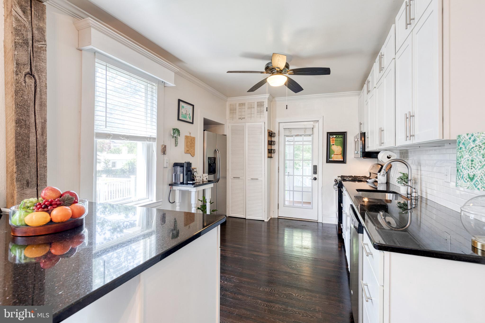 6504 Maplewood Road Baltimore, MD 21212 - Photo 6 of 45 a kitchen with stainless steel appliances granite countertop a stove refrigerator and a sink with granite countertops
