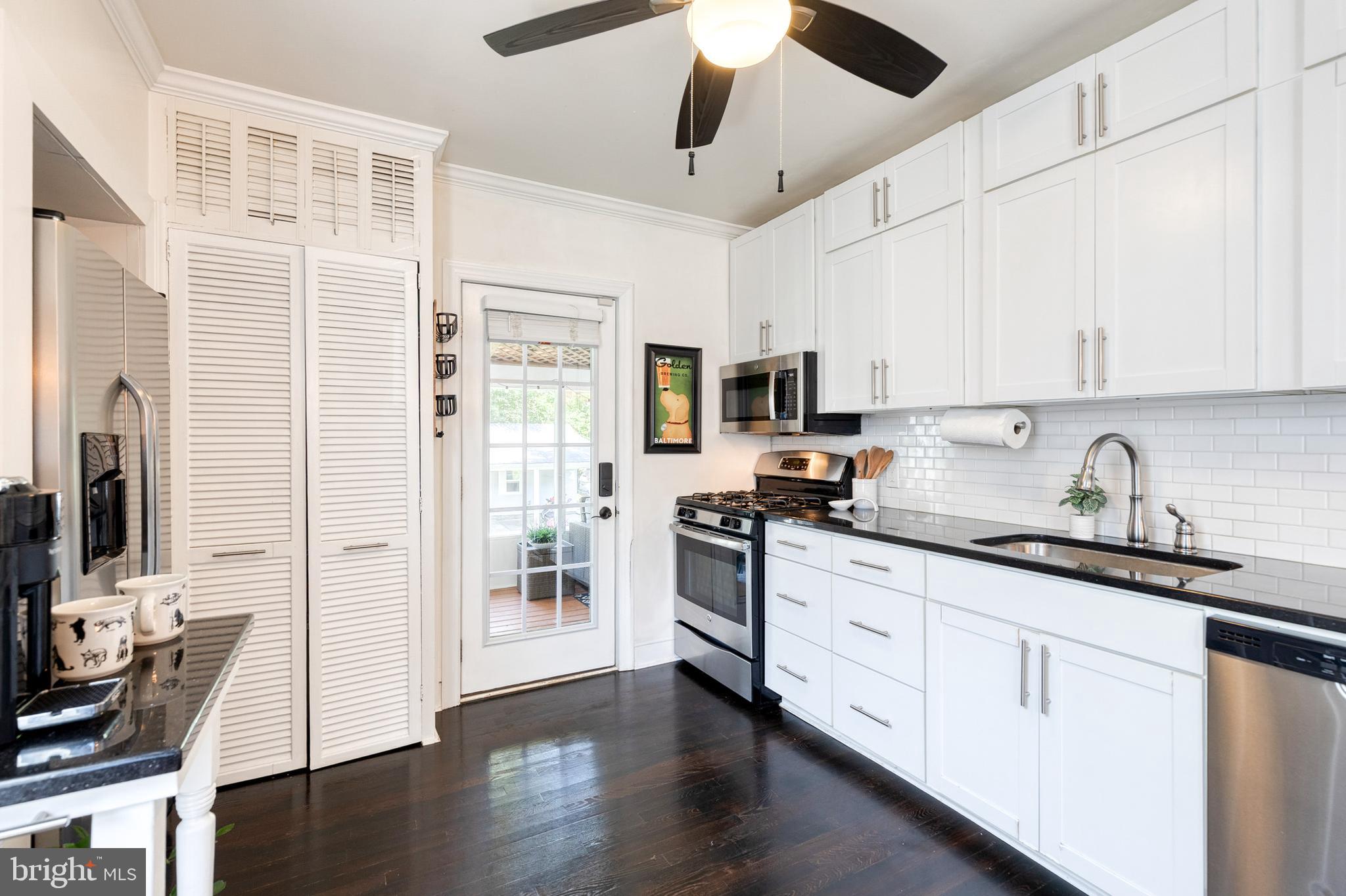 6504 Maplewood Road Baltimore, MD 21212 - Photo 7 of 45 a kitchen with stainless steel appliances granite countertop a stove sink and refrigerator