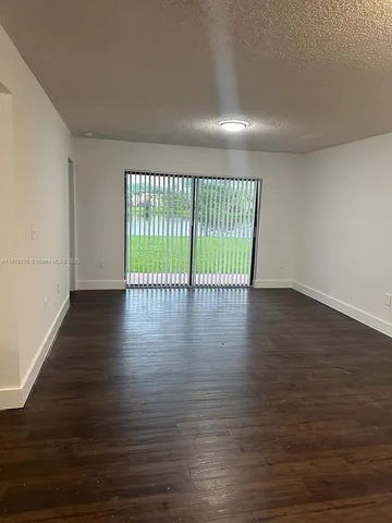 a view of wooden floor and windows in a room
