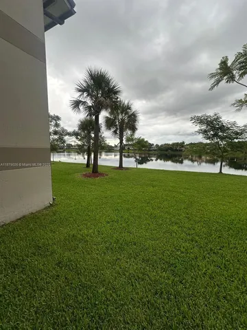 a view of yard with swimming pool and green space
