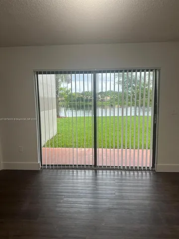 a view of wooden floor and windows in a room