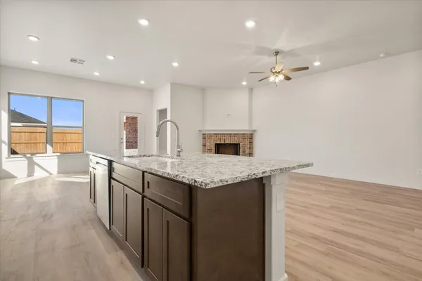 a kitchen with granite countertop cabinets a sink and appliances