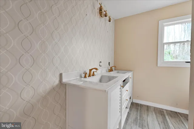 a bathroom with a sink and a mirror