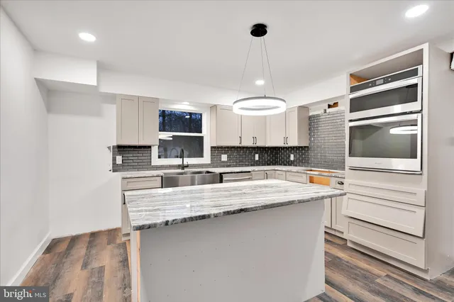 a kitchen with a sink stainless steel appliances and cabinets