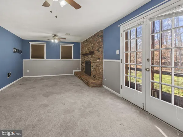 a view of livingroom with furniture ceiling fan and window