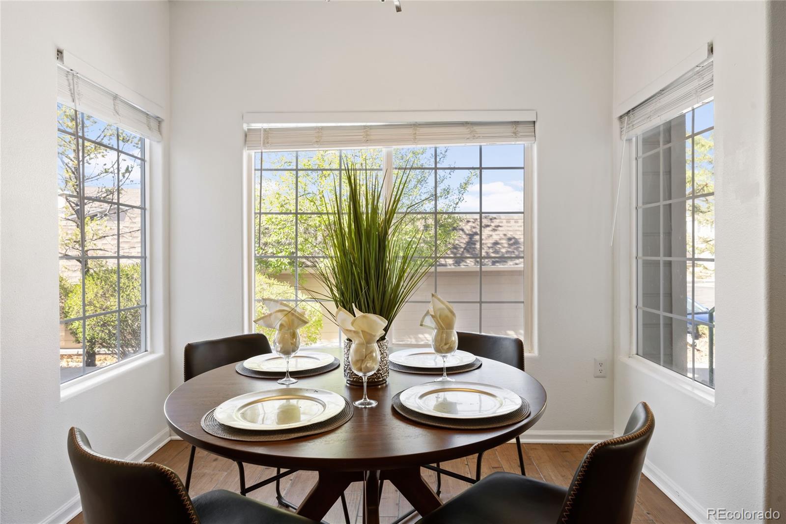 a dining room with furniture a window and chairs