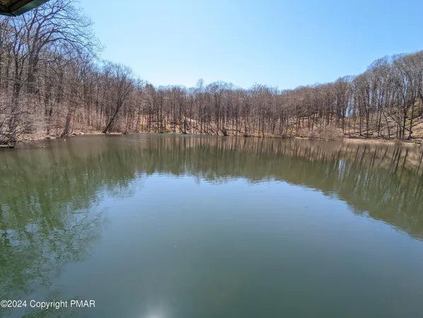 a view of a lake in between two chairs