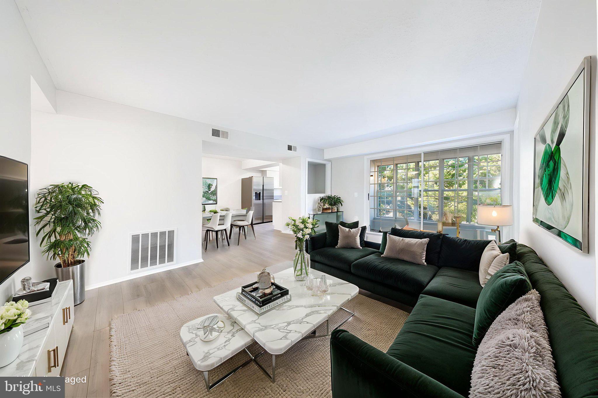 118 Fort Evans Road Southeast, Unit C Leesburg, VA 20175 - Photo 11 of 35 a living room with furniture and a large window