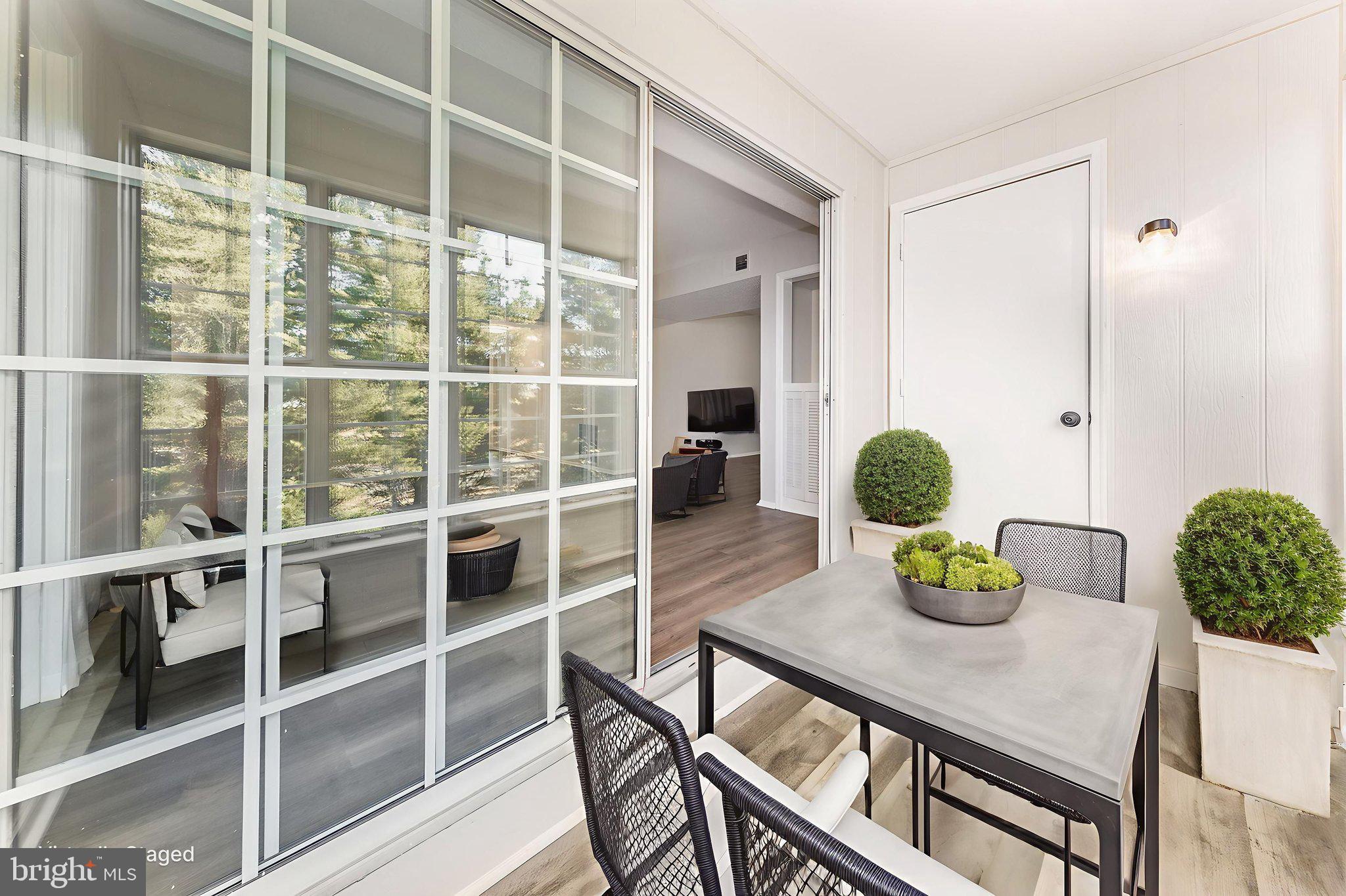 118 Fort Evans Road Southeast, Unit C Leesburg, VA 20175 - Photo 15 of 35 a view of a dining room and livingroom with furniture wooden floor and a window