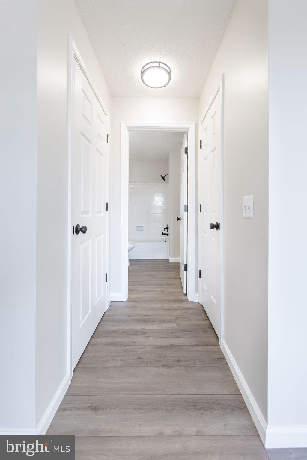118 Fort Evans Road Southeast, Unit C Leesburg, VA 20175 - Photo 19 of 35 a view of a hallway with wooden floor