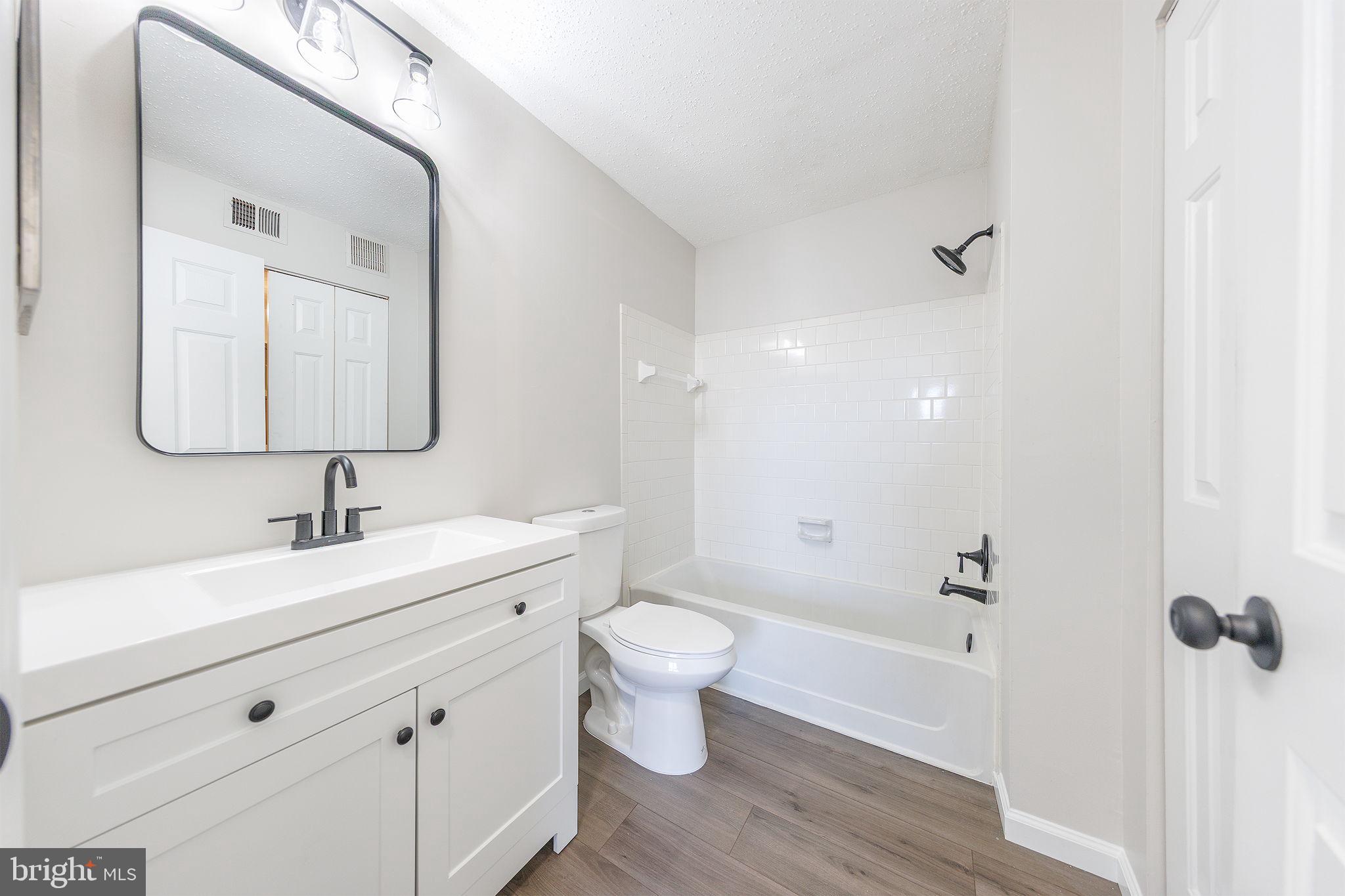 118 Fort Evans Road Southeast, Unit C Leesburg, VA 20175 - Photo 20 of 35 a bathroom with a sink a toilet and shower