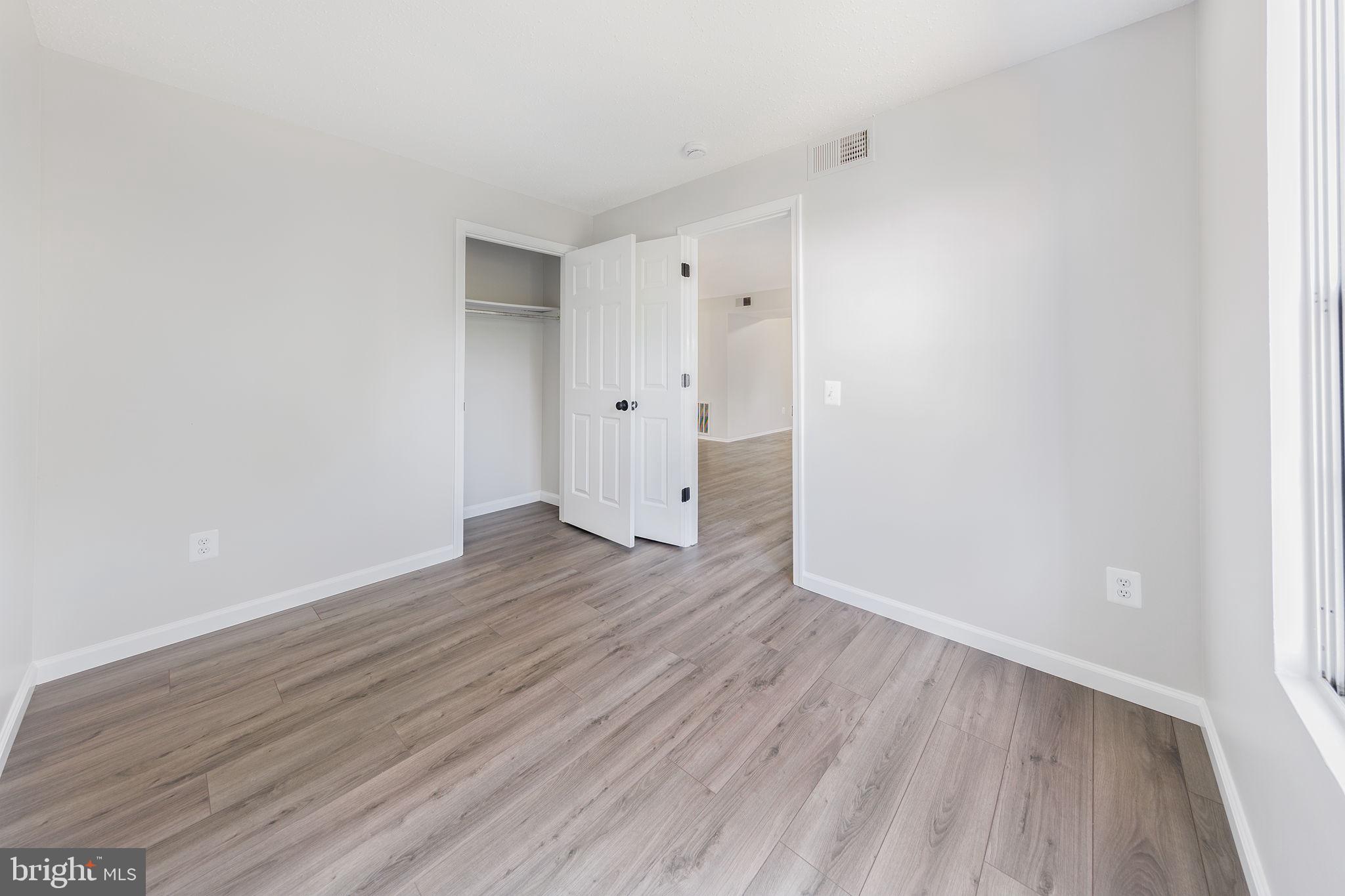 118 Fort Evans Road Southeast, Unit C Leesburg, VA 20175 - Photo 26 of 35 a view of an empty room with wooden floor