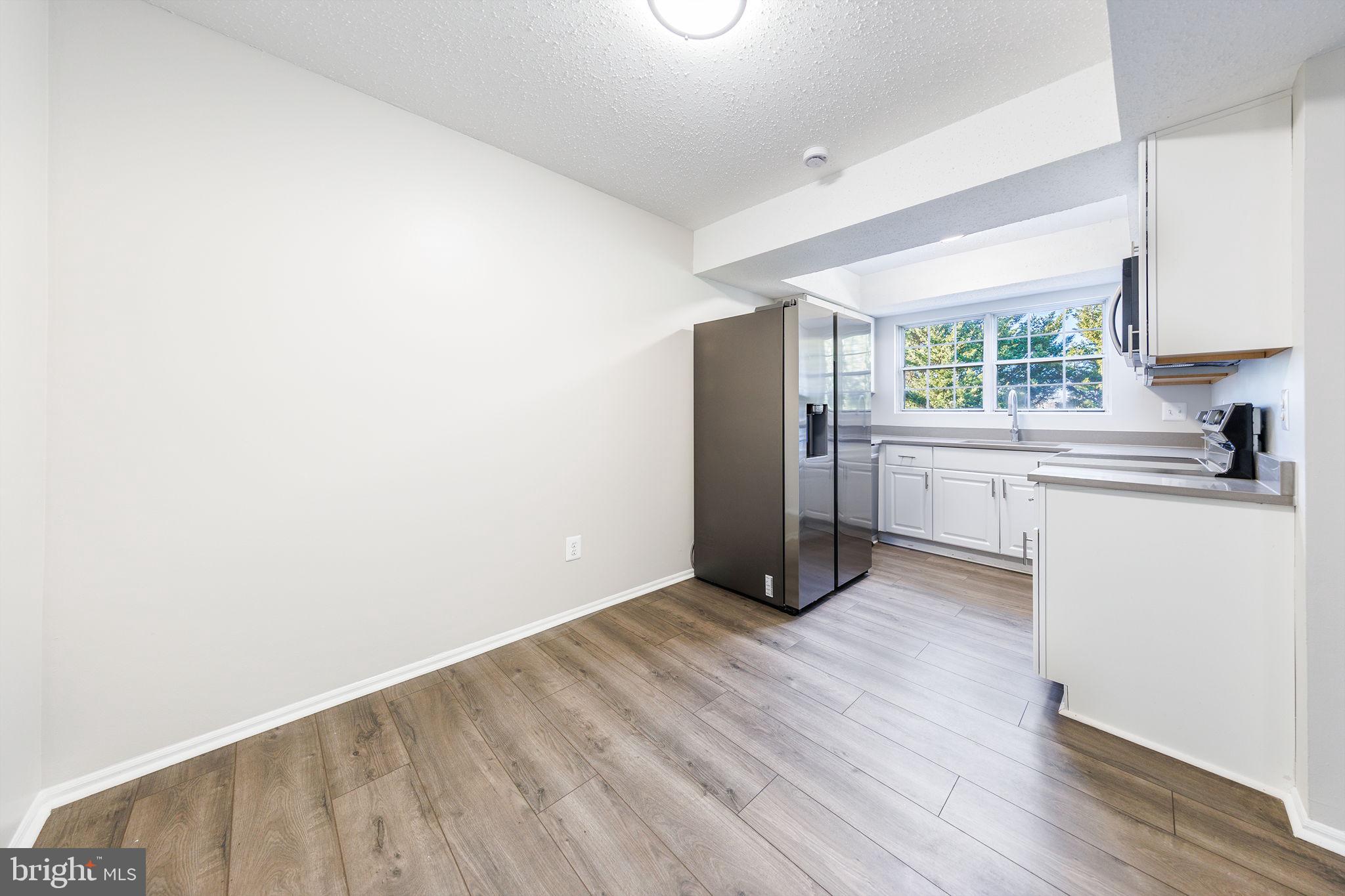 118 Fort Evans Road Southeast, Unit C Leesburg, VA 20175 - Photo 8 of 35 a view of kitchen with cabinets and wooden floor