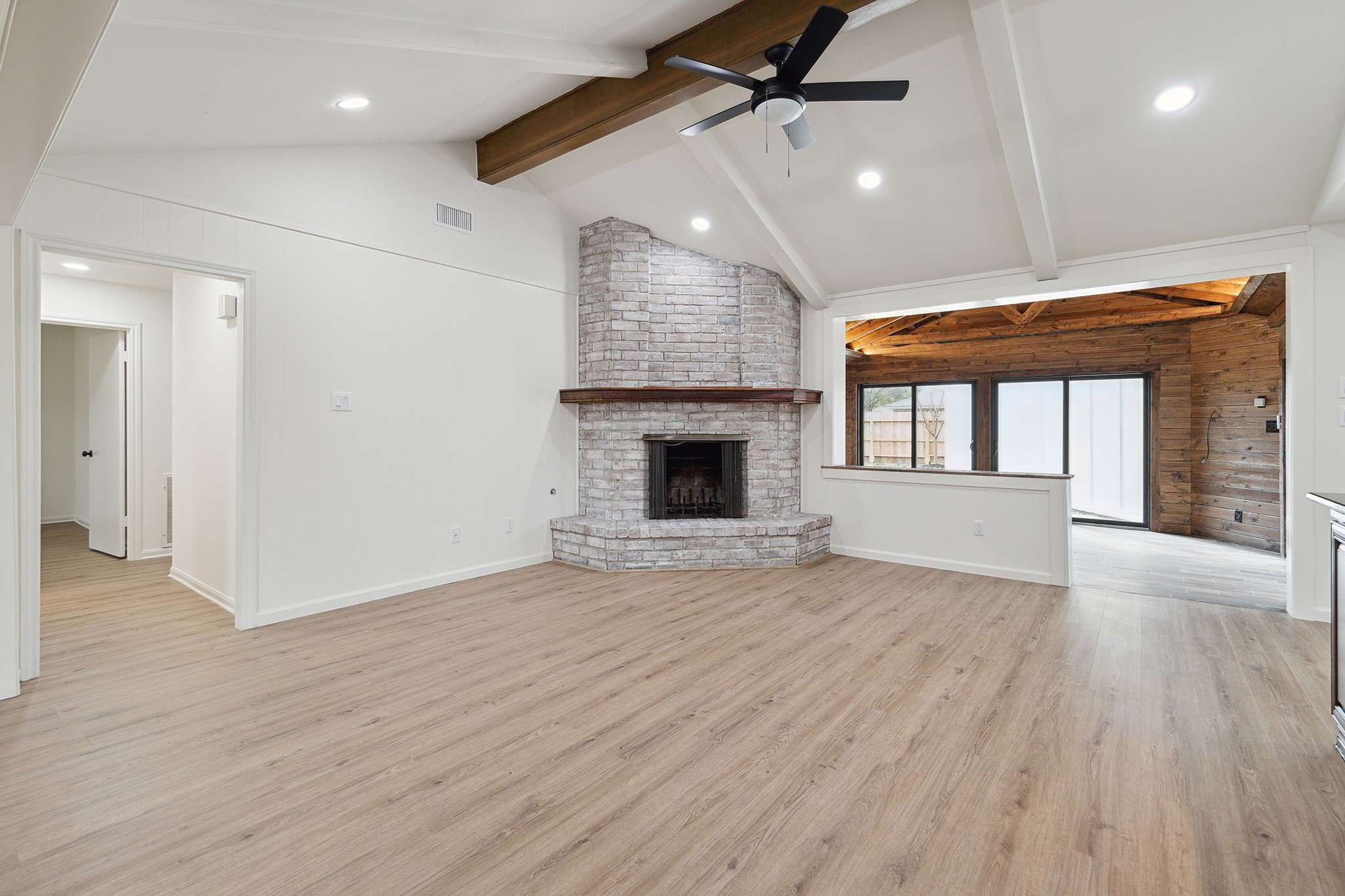 9719 Springmont Drive Houston, TX 77080 - Photo 8 of 32 Another angle of the central living room, subtly separated from the adjoining sunroom by a half-wall. Separate but visually still connected so the whole space is filled with natural light!