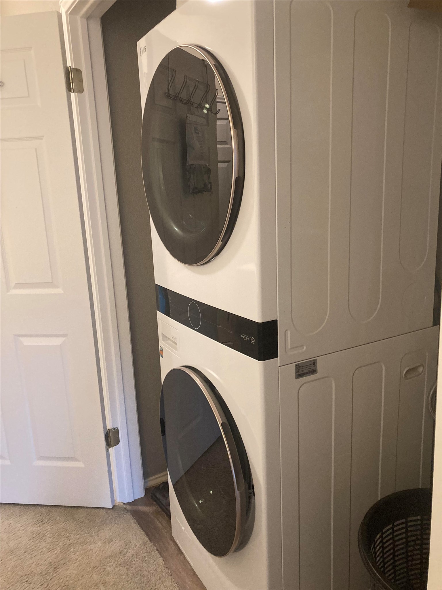 12401 Los Indios Trail, Unit 32 Austin, TX 78729 - Photo 21 of 39 A dedicated laundry space features a modern stacked washer and dryer unit, maximizing utility.