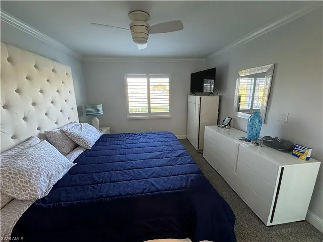 a bedroom with bed and wooden floor
