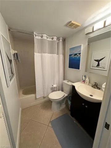 a bathroom with a sink toilet a mirror and shower