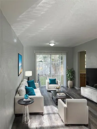 a living room with furniture and a large window