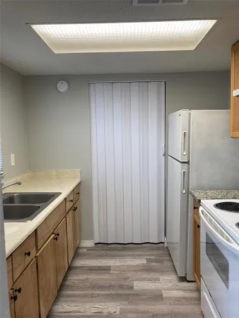a kitchen with a sink cabinets and stainless steel appliances