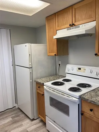 a kitchen with a stove and a refrigerator