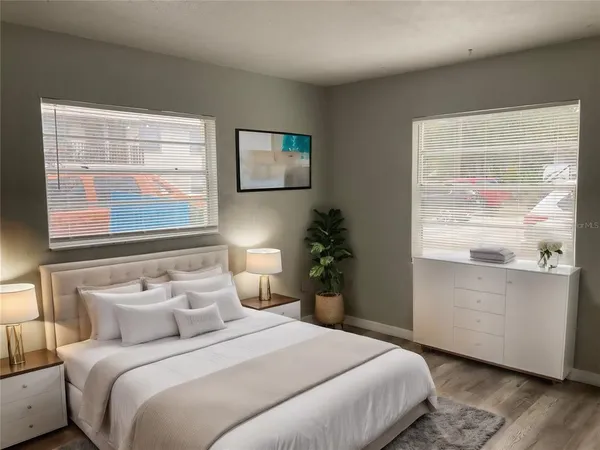 a bedroom with a bed and a window