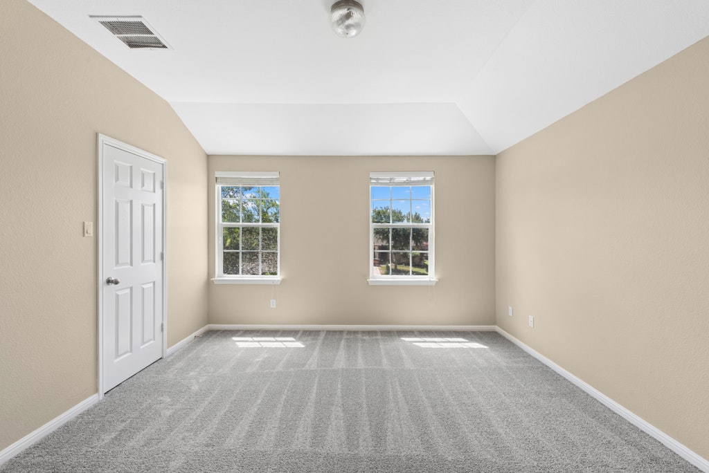 458 Nottingham Loop Kyle, TX 78640 - Photo 22 of 38 an empty room with wooden floor and windows