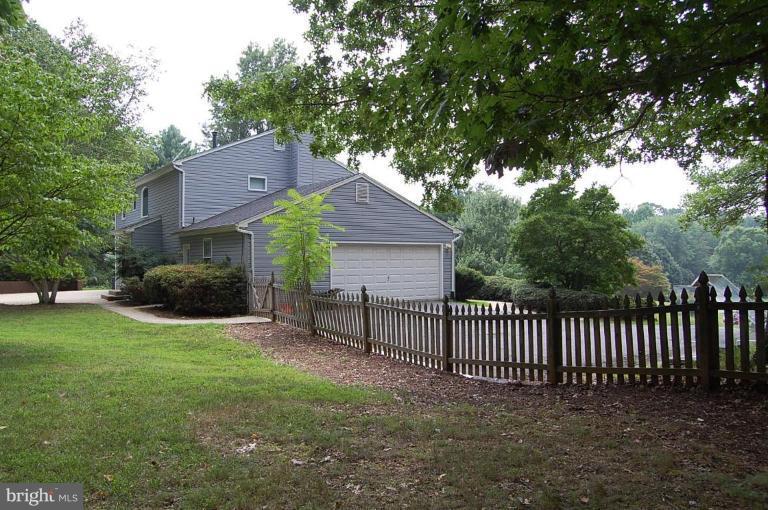 10901 Equestrian Court Reston, VA 20190 - Photo 17 of 18 View of side load two car garage from fenced yard