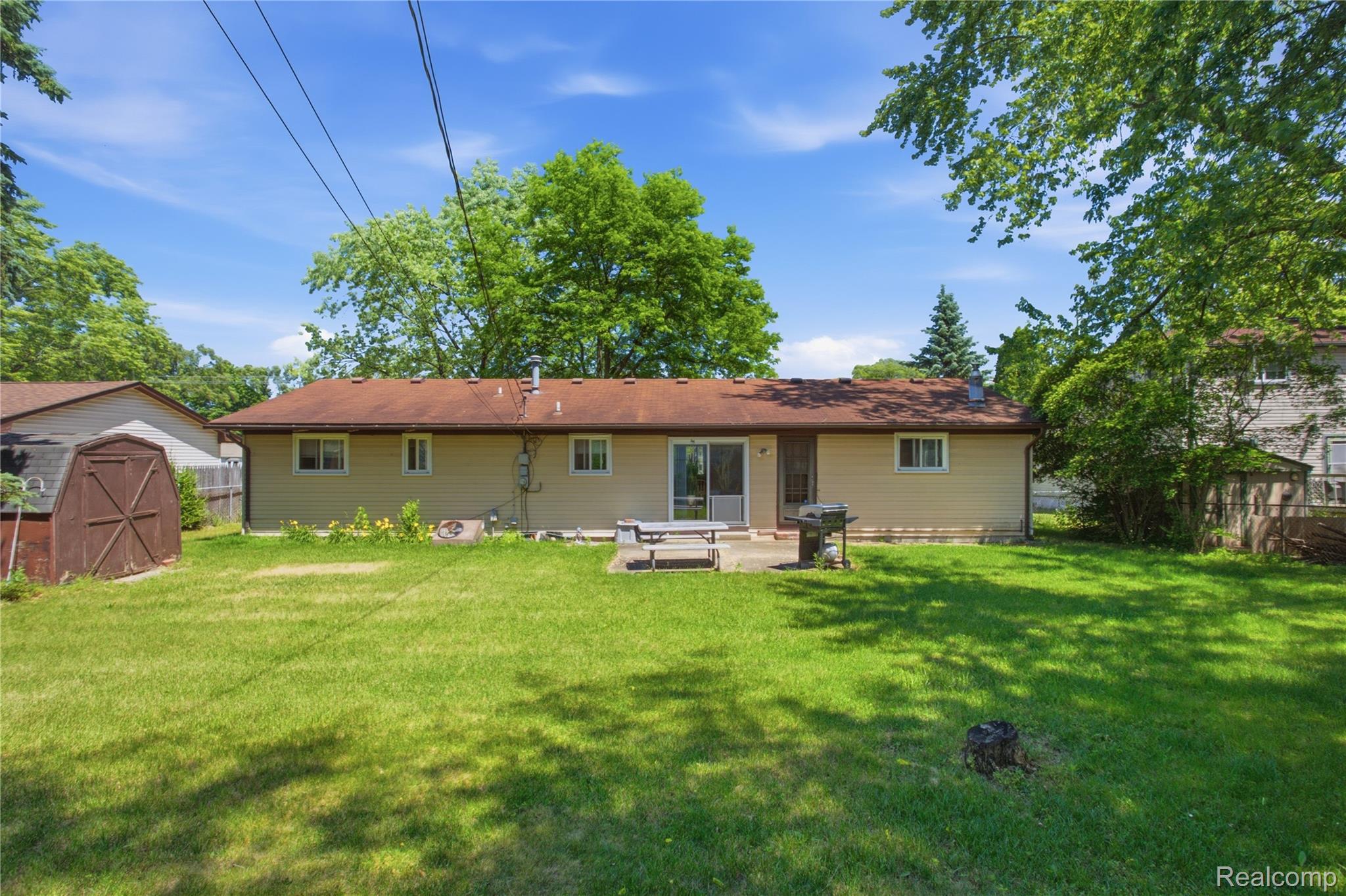 47395 Dequindre Road Rochester, MI 48307 - Photo 15 of 19 Expansive green lawn with a concrete patio