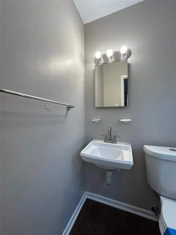 a bathroom with a sink a toilet and mirror