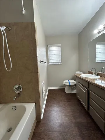 a bathroom with a double vanity sink and a toilet